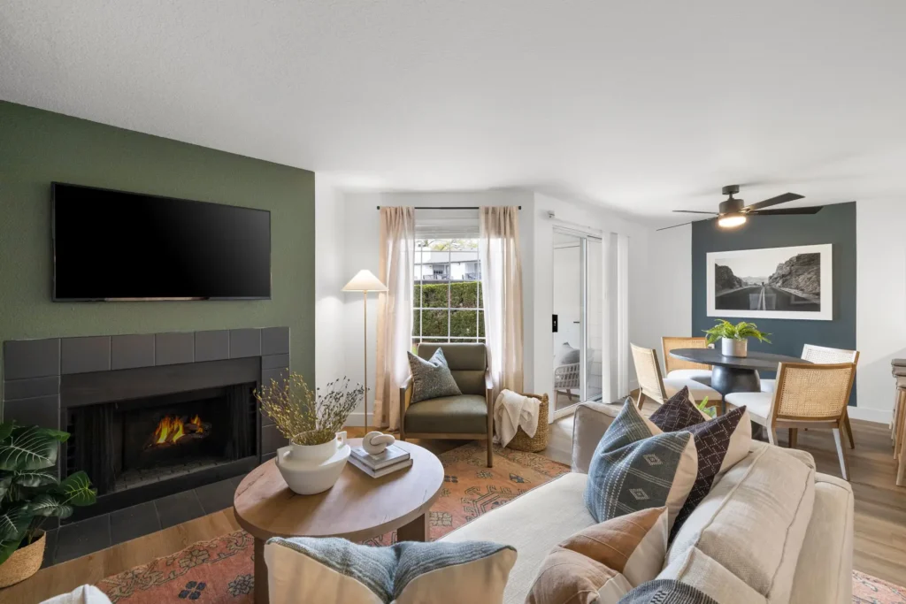 living area with fire place large windows, looking into dining area