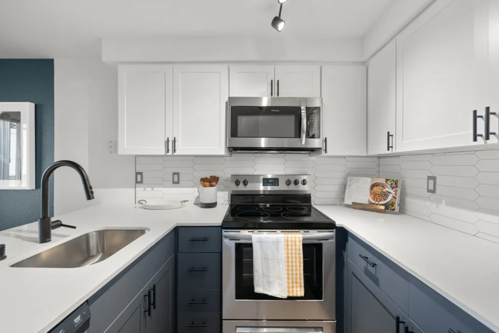 kitchen with white countertops and cabinets, stainless steel appliances