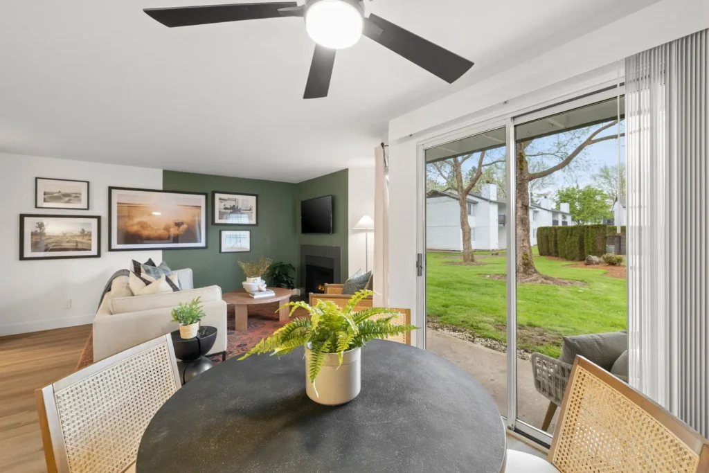 dining and living area with larger glass doors leading outside to green space