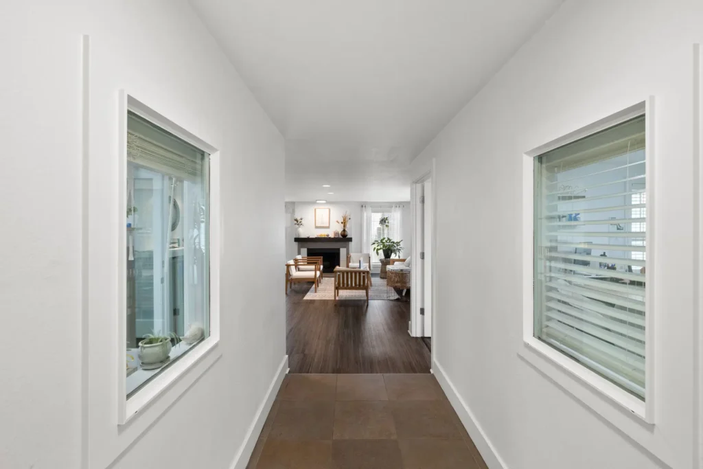 hallway leading to large room with lounge seating