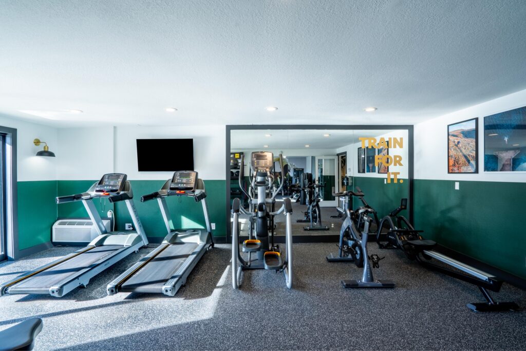 Gym interior with treadmills and other exercise equipment.
